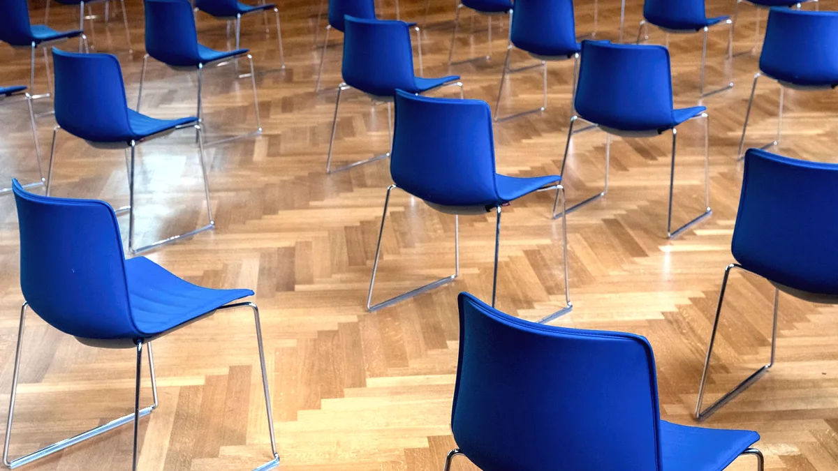 A row of identical chairs, one after another.