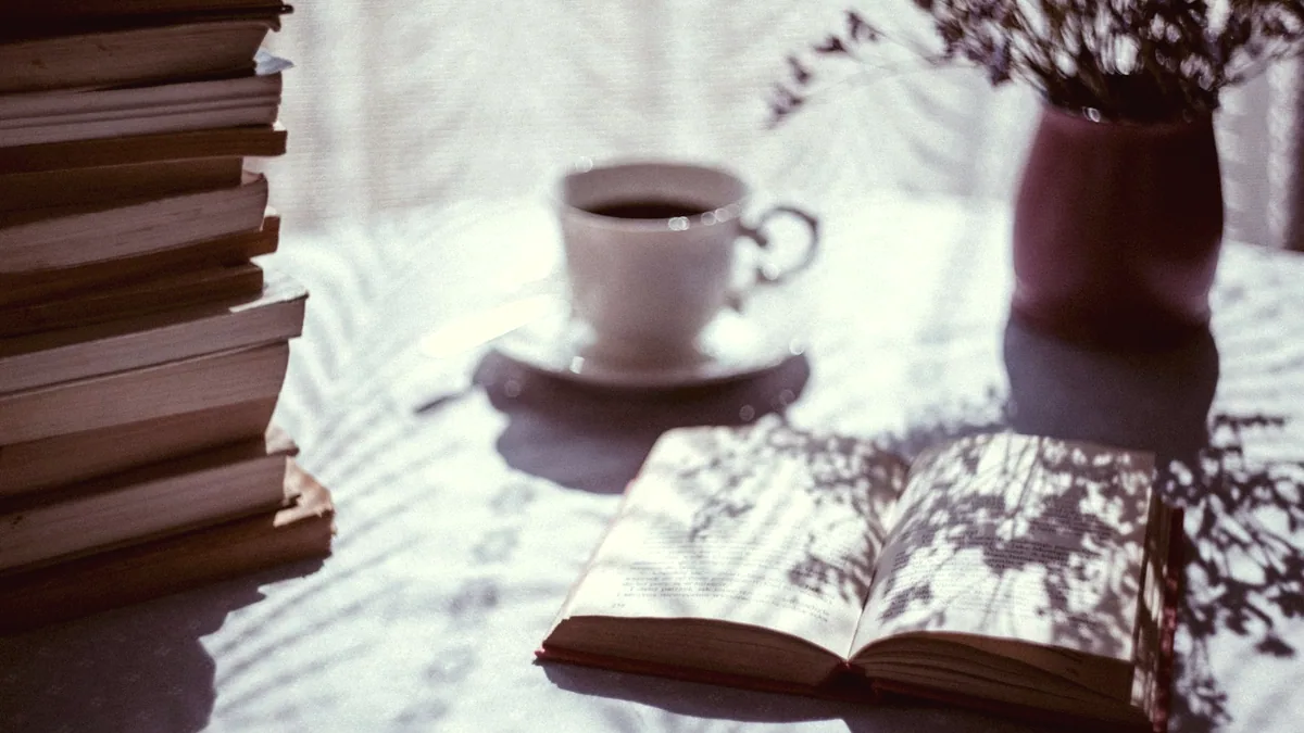 An open book on a table under warm light.