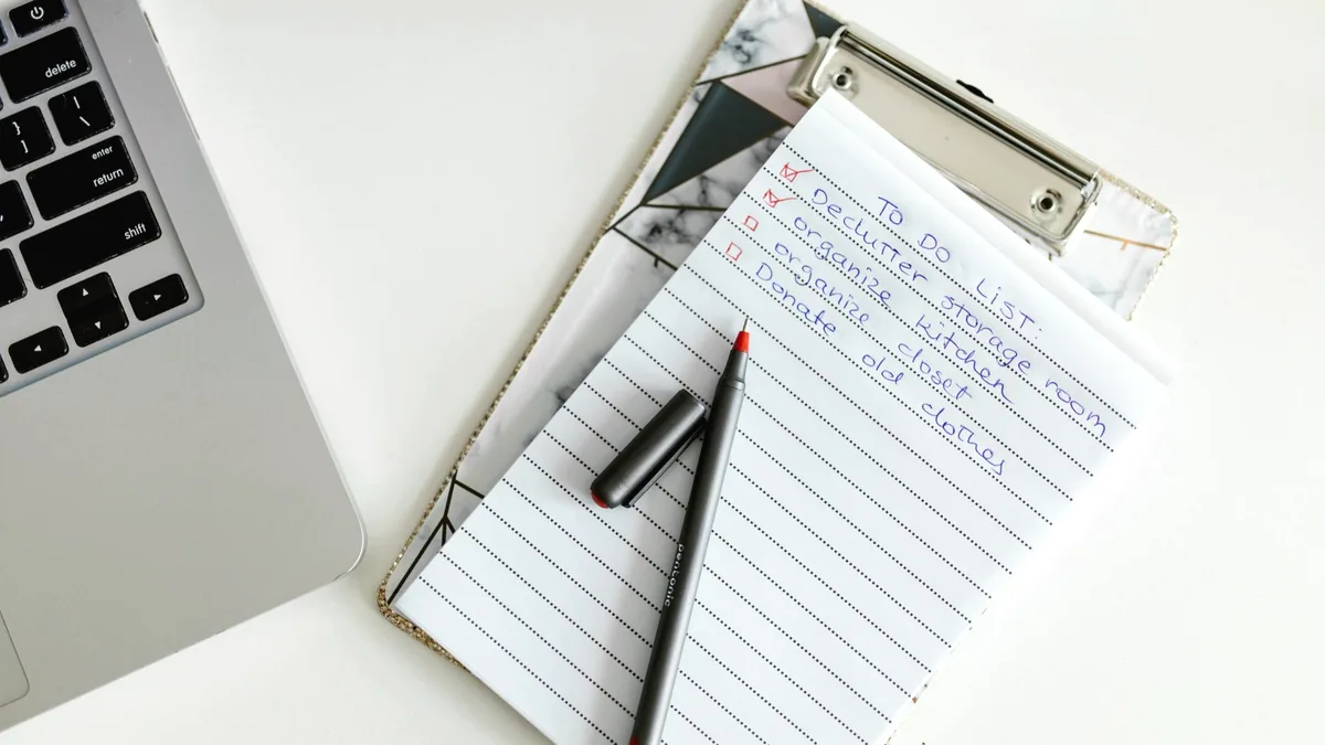 Notes and figures on paper, held on a clipboard.