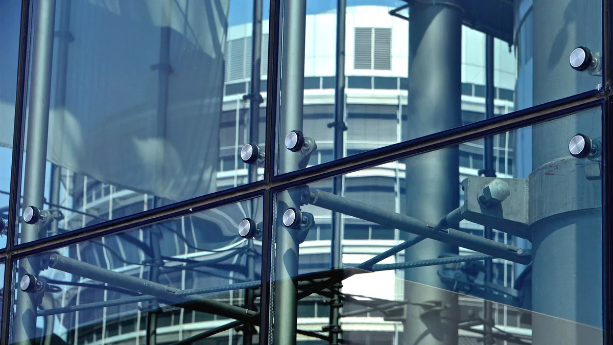 A reflection in a pane of glass, two things visible at once.