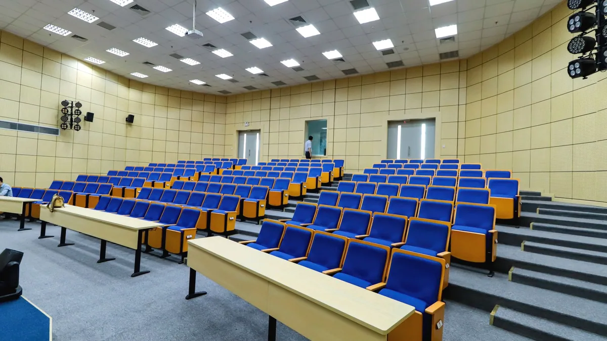The empty seats of a school auditorium.