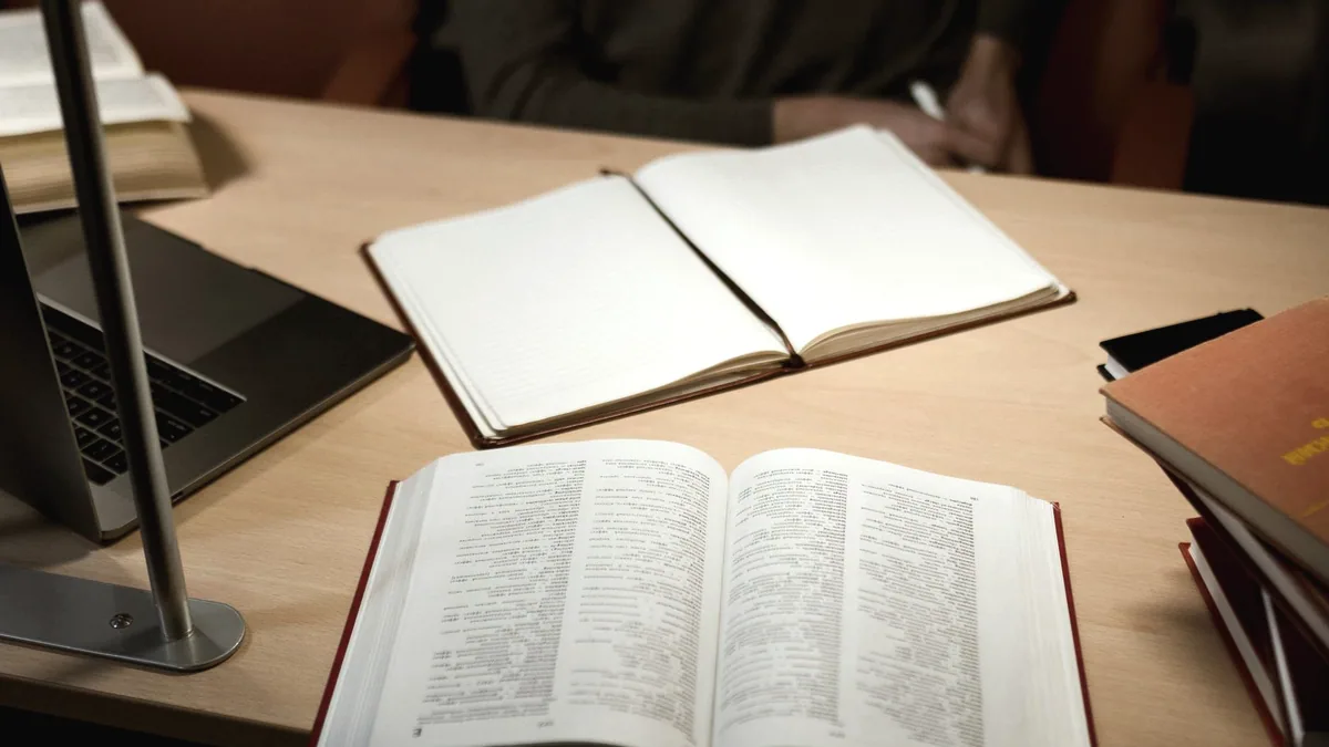 An open notebook under a lamp.