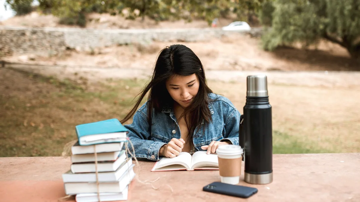 A teenager reading a book.