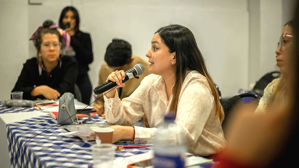 A young person speaking into a microphone.