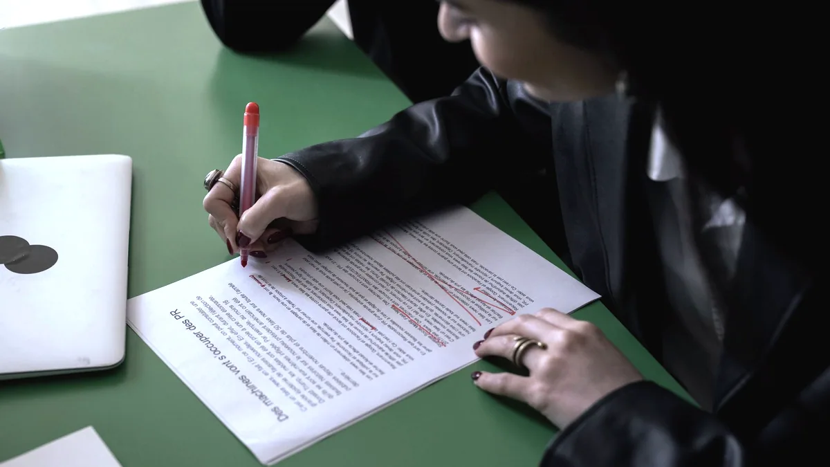 A page of typed writing marked up in red.