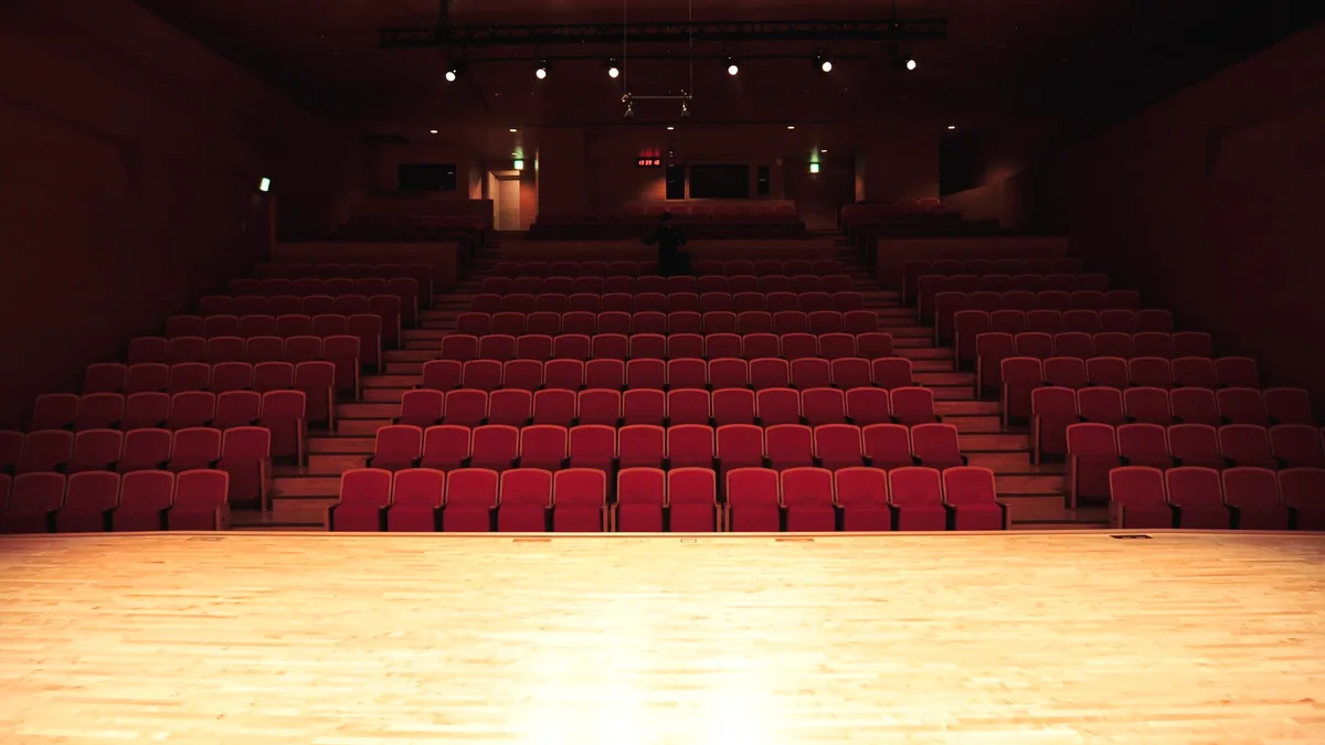 An empty auditorium with the stage lights on.