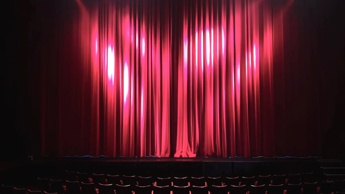 An empty stage under a spotlight, before anyone is on it.