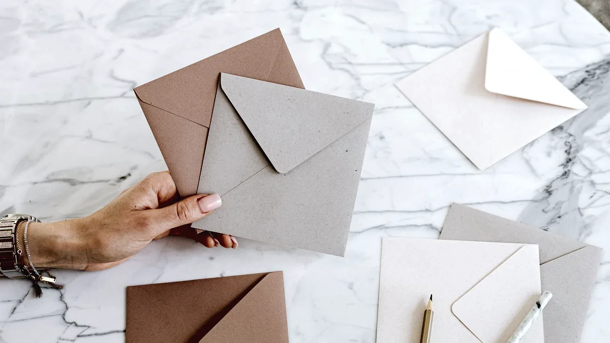 An envelope and a folded letter on a desk.