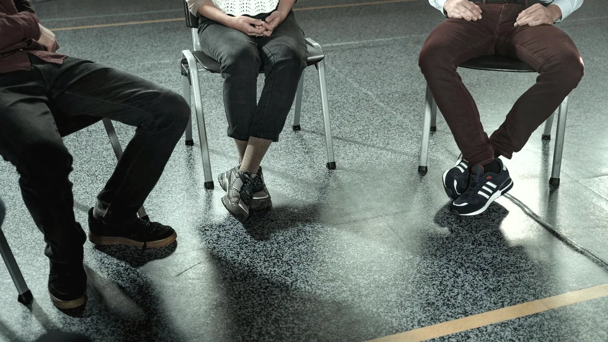Chairs set out in a circle in an empty room.